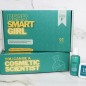 Dear Smart Girl Cosmetic Scientist STEM Kit standing on top of another of the same kit. Hand soap and sugar scrub made from kit sitting next to boxes.